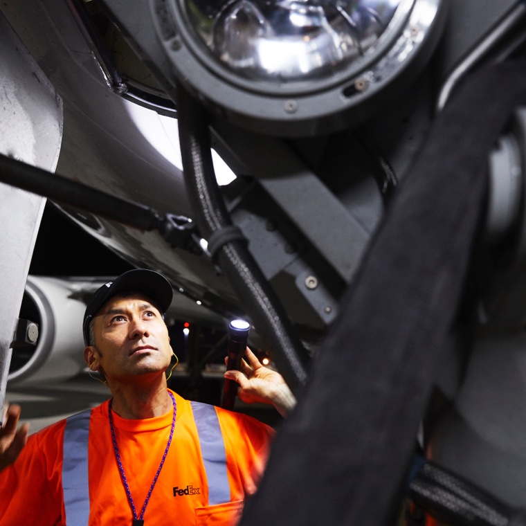 Worker holding flashlight inpecting